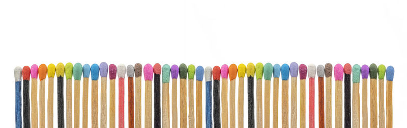 Close-up of colored pencils against white background