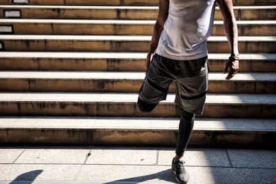 Low section of man standing on staircase