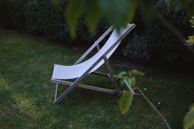 Empty chair on field in park