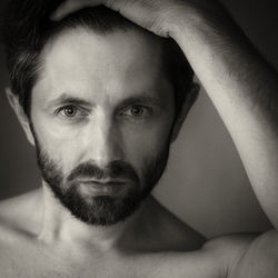 Close-up portrait of shirtless man at home