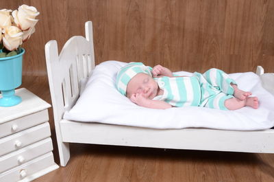 High angle view of baby boy sleeping on bed at home