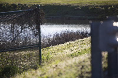 Scenic view of field seen through railing