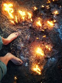 Low section of man against orange fire