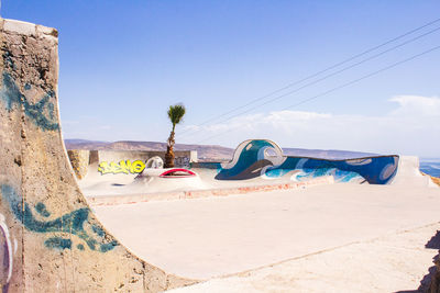 Panoramic view of beach against clear blue sky