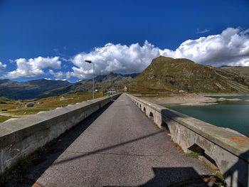 Road by lake against sky