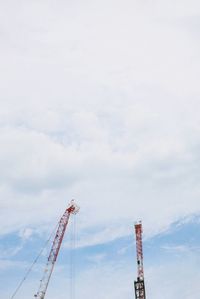 Low angle view of crane against sky