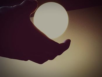 Close-up of hand holding illuminated lamp