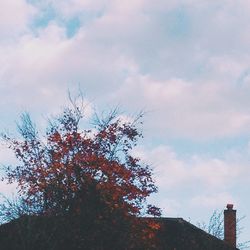 Low angle view of building against cloudy sky