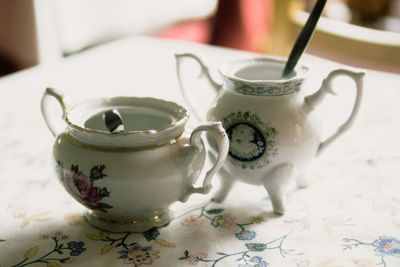 Close-up of teapots on table at cafe