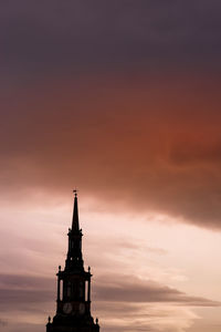 Silhouette of building against cloudy sky during sunset