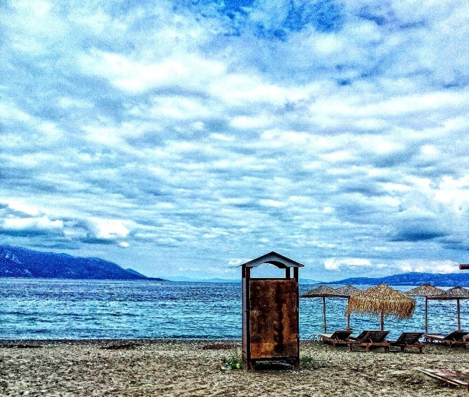 sky, cloud - sky, water, sea, cloudy, tranquility, beach, built structure, tranquil scene, cloud, nature, scenics, blue, shore, architecture, beauty in nature, day, outdoors, weather, horizon over water