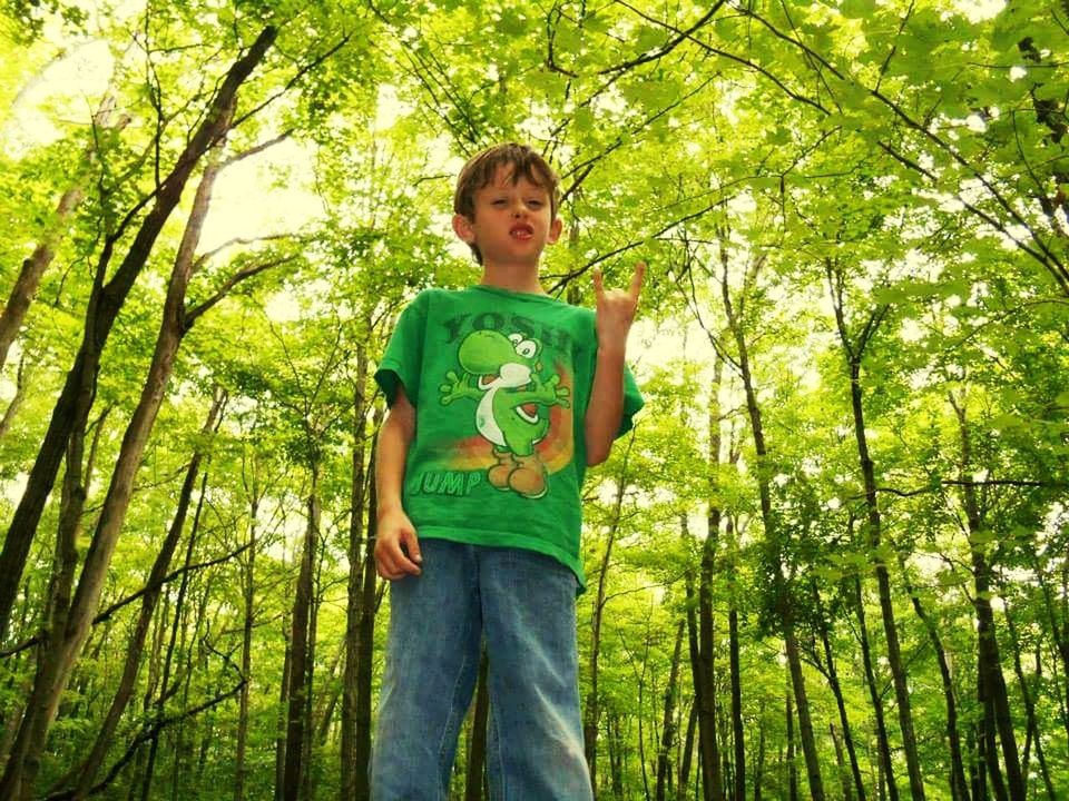 FULL LENGTH OF BOY STANDING IN FOREST