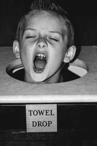 Boy stuck in towel drop container