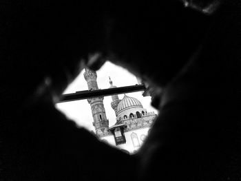 Close-up portrait of silhouette man holding cross