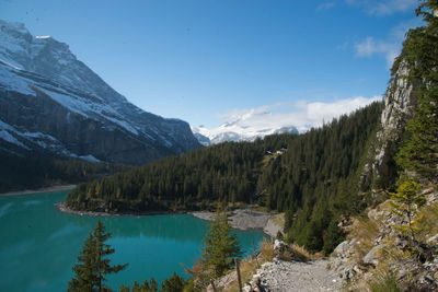Scenic view of lake by mountains against sky