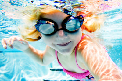 Close-up portrait of girl swimming in pool