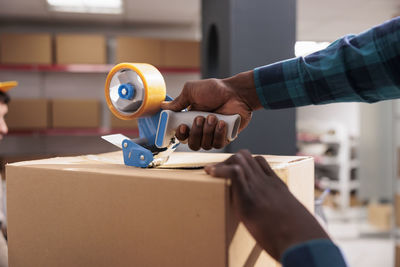 Cropped hands of man working at home