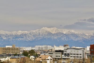 High angle view of townscape and mountains against sky