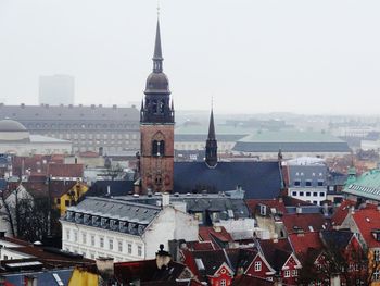 Buildings in city against clear sky