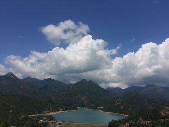 Scenic view of lake and mountains against sky