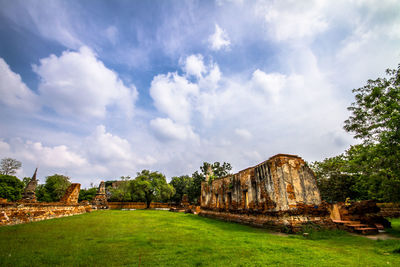 Old ruins on field against sky