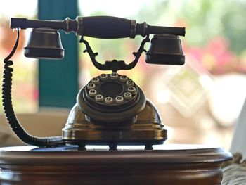 Close-up of telephone booth on table