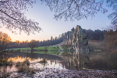 Scenic view of lake against sky at sunset