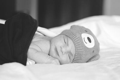 Close-up of baby sleeping on bed