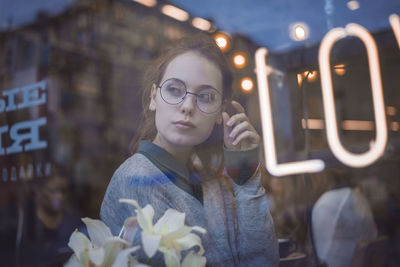 Portrait of young woman standing outdoors