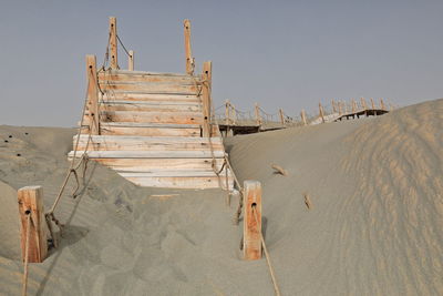 Lifeguard hut on land against clear sky