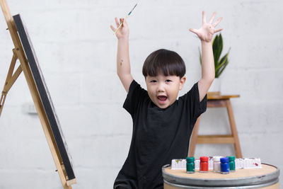 Portrait of cute boy holding camera