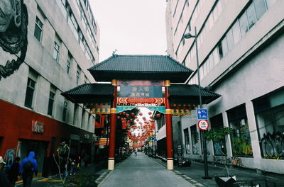Street amidst buildings in city against clear sky