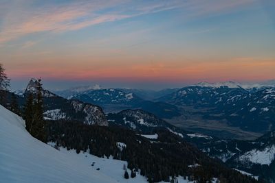 Scenic view of snowcapped mountains against sky during sunset