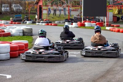 Racing excitement at a karting circuit on a bright day with friends enjoying the thrill together