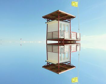 Low angle view of lifeguard hut at beach against clear sky