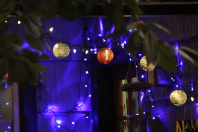 Low angle view of illuminated lanterns hanging at night