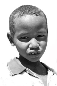 Close-up portrait of boy against white background