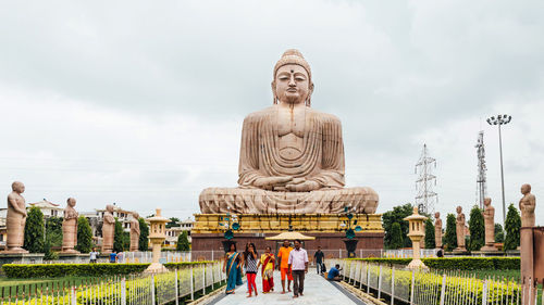 Statue against temple against sky