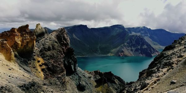 Panoramic view of sea and mountains against sky