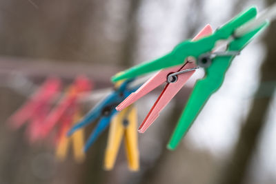 Close-up of multi colored clothespins hanging on clothesline