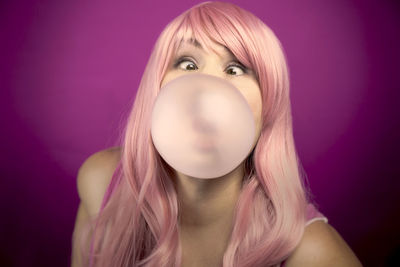 Portrait of young woman blowing bubbles