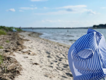 Rear view of beach against sky