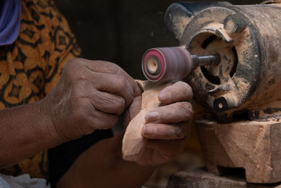 Midsection of man working at machine