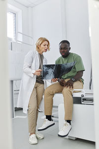 Doctor explaining x-ray to patient sitting in clinic