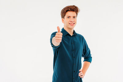 Portrait of a smiling man standing against white background