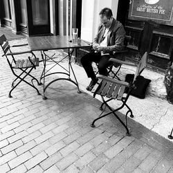 Young man sitting on chair