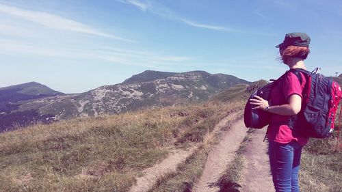 Full length of man standing on mountain road against sky