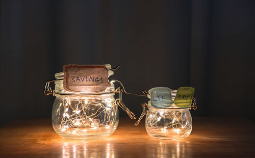 Close-up of labels on glass jars on wooden table