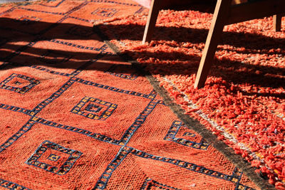High angle view of red rug on sunny day