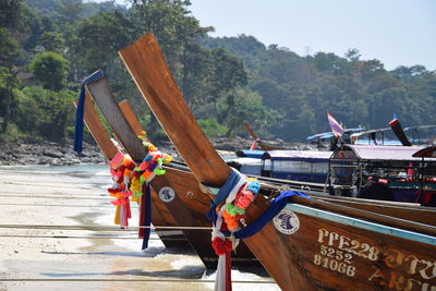 Boat moored on shore against sky